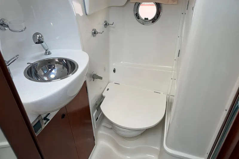 All At Sea Yacht Photos Pics Compact bathroom in 2007 Beneteau Swift Trawler 42 with sink and toilet.