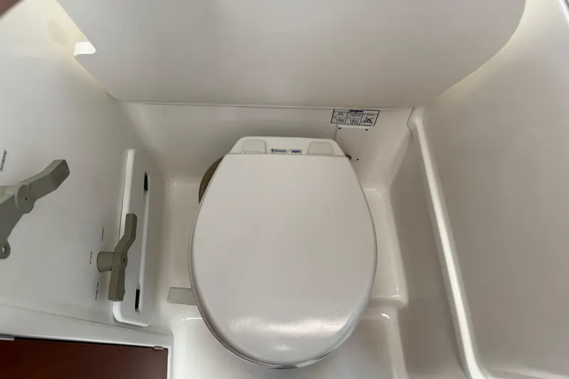 All At Sea Yacht Photos Pics 2007 Beneteau Swift Trawler 42 bathroom with white marine toilet.