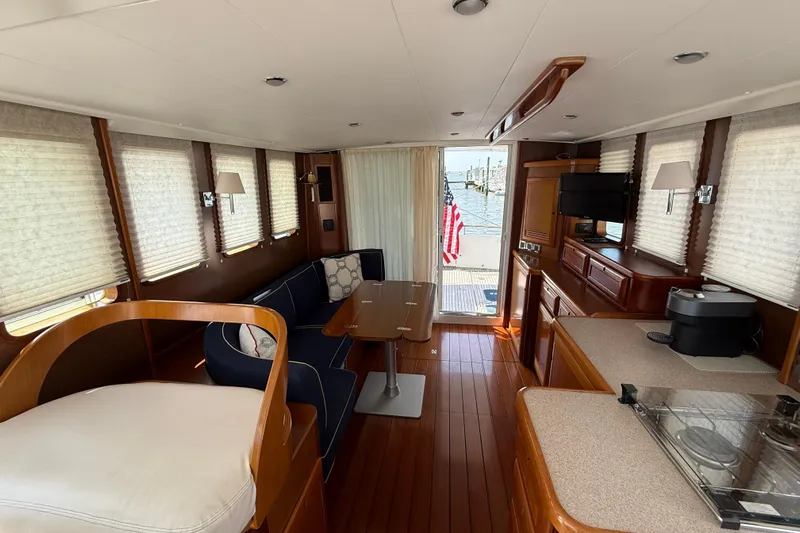 All At Sea Yacht Photos Pics Interior of 2007 Beneteau Swift Trawler 42 with elegant wood finish and cozy seating.