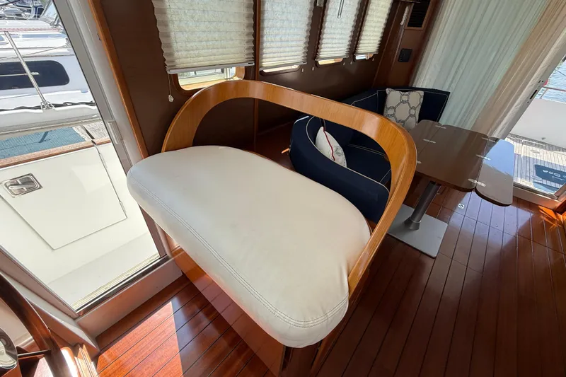 All At Sea Yacht Photos Pics Interior of 2007 Beneteau Swift Trawler 42 with elegant seating and wooden flooring.