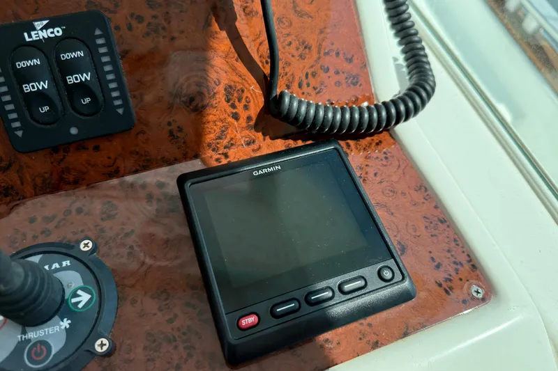 All At Sea Yacht Photos Pics Control panel of 2007 Beneteau Swift Trawler 42 with Garmin display and Lenco controls.