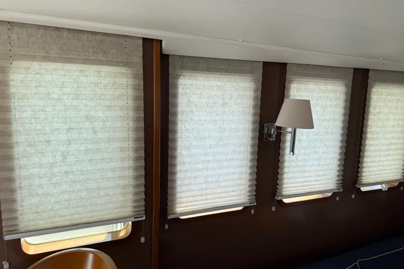 All At Sea Yacht Photos Pics Interior of 2007 Beneteau Swift Trawler 42 with window blinds and wall lamp.