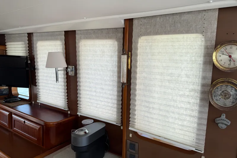 All At Sea Yacht Photos Pics Interior of 2007 Beneteau Swift Trawler 42 with blinds, clock, and lamp.