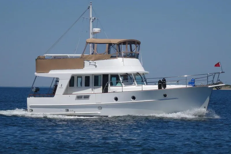 All At Sea Yacht Photos Pics 2007 Beneteau Swift Trawler 42 cruising on open water under clear blue skies.