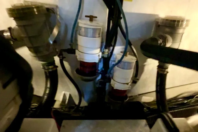 All At Sea Yacht Photos Pics Engine room of a 2007 Beneteau Swift Trawler 42, showcasing mechanical components and hoses.