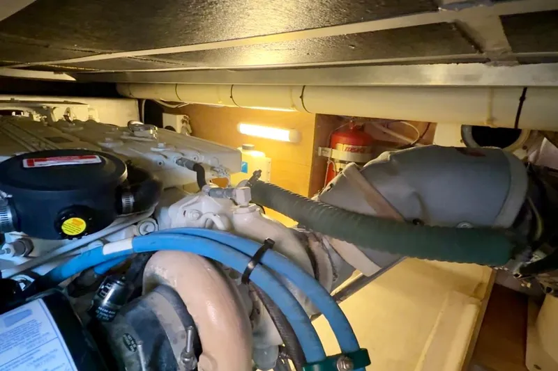 All At Sea Yacht Photos Pics Engine room of 2007 Beneteau Swift Trawler 42 with visible pipes and equipment.