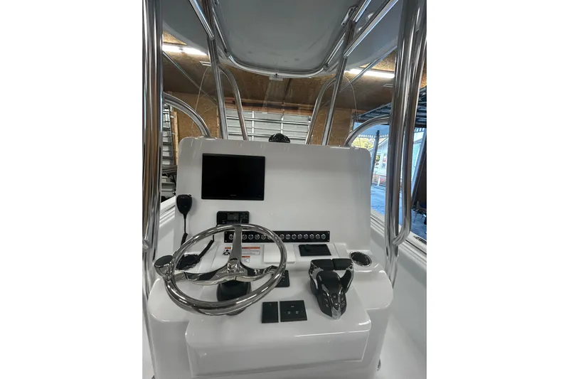  Yacht Photos Pics 2024 Contender 24 Sport boat console with steering wheel and controls.