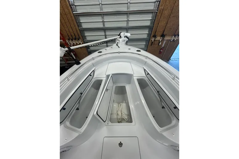  Yacht Photos Pics 2024 Contender 24 Sport boat interior with open storage compartments and rope.