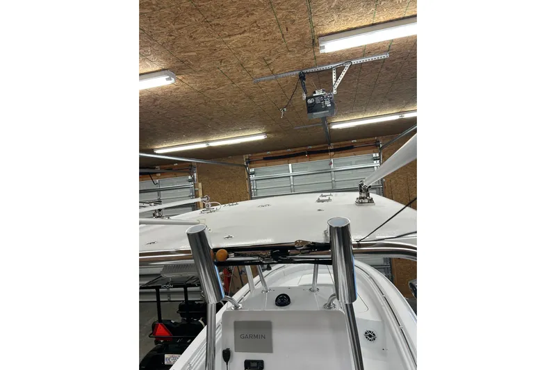  Yacht Photos Pics 2024 Contender 24 Sport boat in a garage with Garmin equipment visible.