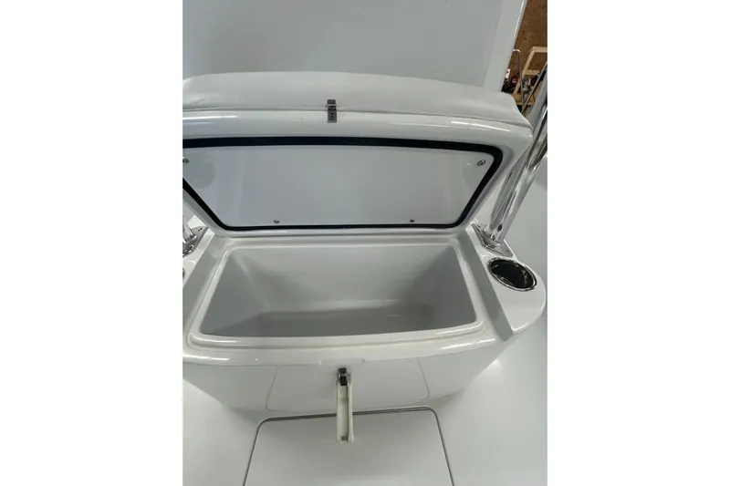  Yacht Photos Pics Open storage compartment on 2024 Contender 24 Sport boat, featuring sleek design and cup holder.