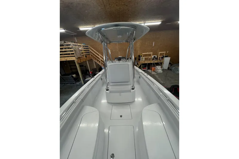  Yacht Photos Pics 2024 Contender 24 Sport boat interior with T-top in a garage setting.