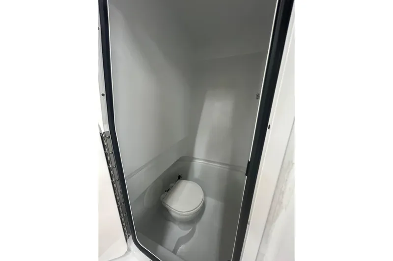  Yacht Photos Pics 2024 Contender 24 Sport boat interior with compact marine toilet.