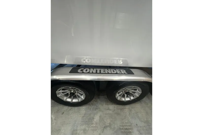  Yacht Photos Pics 2024 Contender 24 Sport boat trailer with dual wheels and branded fender.