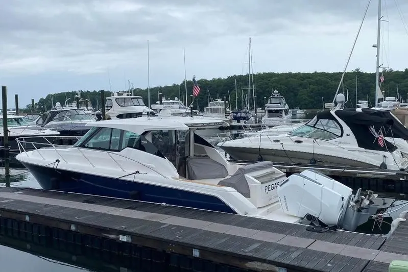 Only 113 Hours Yacht Photos Pics 2023 Tiara Yachts 43 LS docked at a marina with other boats.