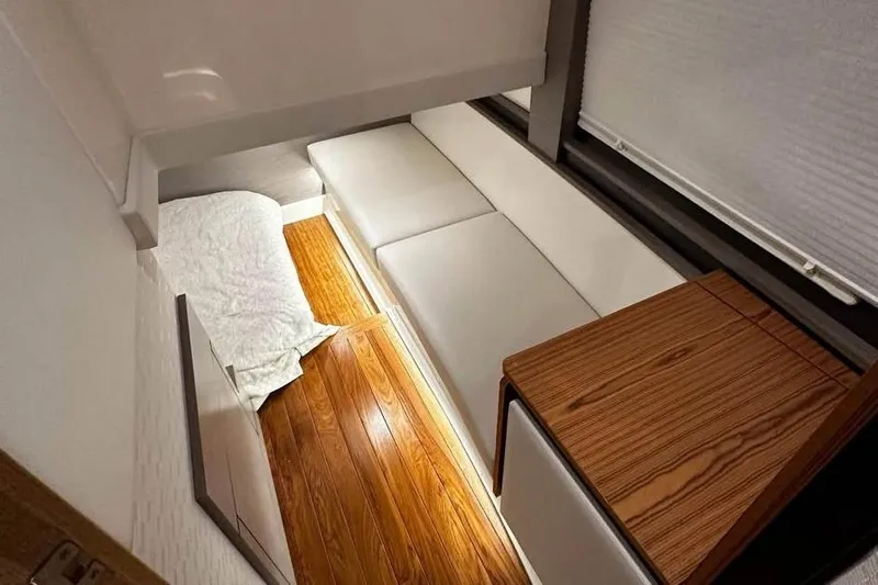 Only 113 Hours Yacht Photos Pics 2023 Tiara Yachts 43 LS interior with wooden flooring and white seating.