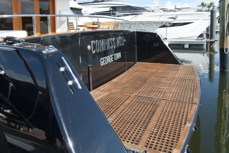 Compass Rose Yacht Photos Pics Luxury yacht "Compass Rose" docked, featuring wooden deck, Custom Heisley 1995 model.