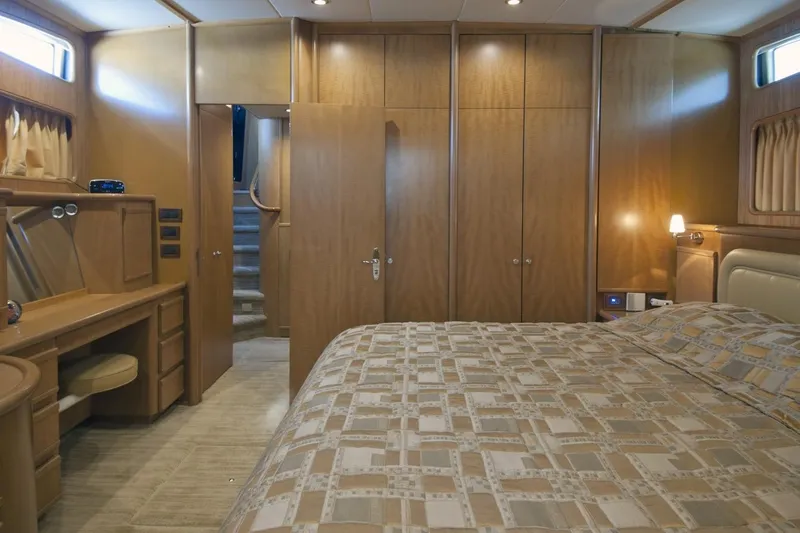 Compass Rose Yacht Photos Pics Luxurious 1995 Custom Heisley yacht bedroom with wood paneling and elegant decor.