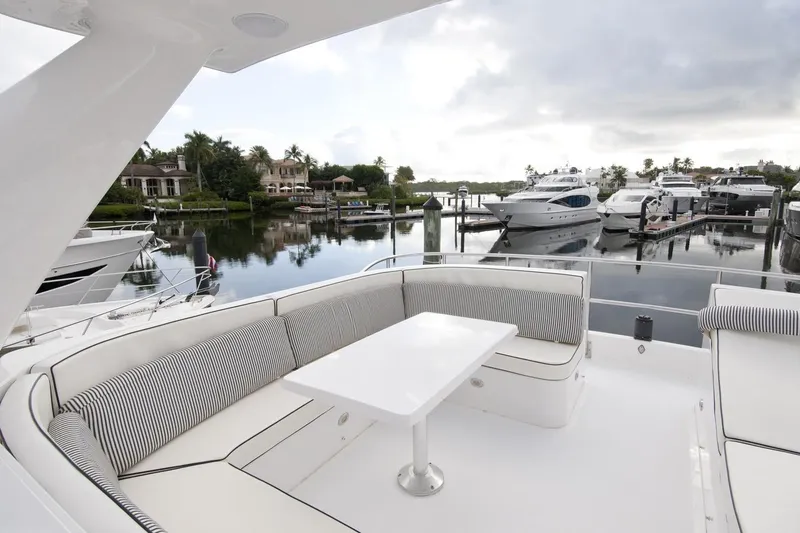 Compass Rose Yacht Photos Pics Luxurious 1995 Custom Heisley yacht with elegant seating, docked in a serene marina.