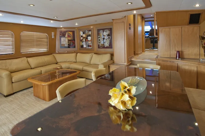 Compass Rose Yacht Photos Pics Luxurious yacht interior with beige leather seating, wooden accents, and modern art, Custom Heisley 1995.