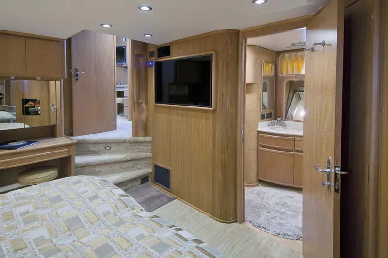 Compass Rose Yacht Photos Pics Luxurious 1995 Custom Heisley RV interior with bedroom and bathroom, featuring wood finishes and modern amenities.