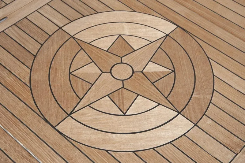 Compass Rose Yacht Photos Pics Wooden star inlay design on Custom Heisley 1995 surface, featuring geometric patterns.