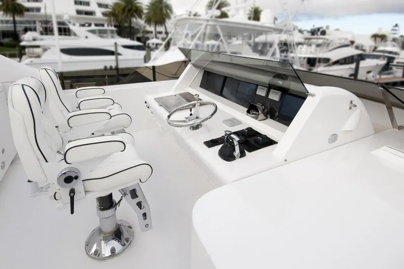 Compass Rose Yacht Photos Pics Luxurious 1995 Custom Heisley yacht helm with white leather seats and modern controls.