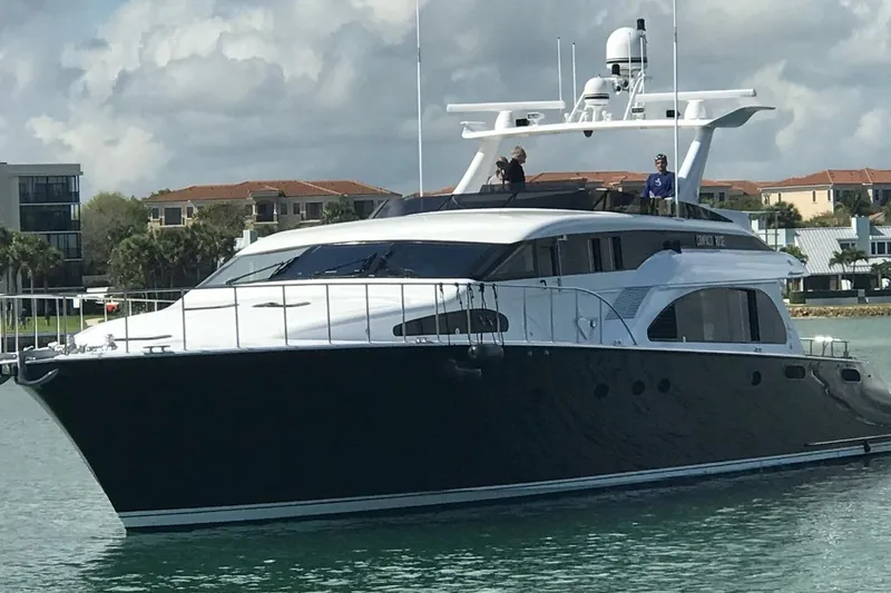 Compass Rose Yacht Photos Pics Luxury 1995 Heisley Flybridge yacht cruising near waterfront homes.