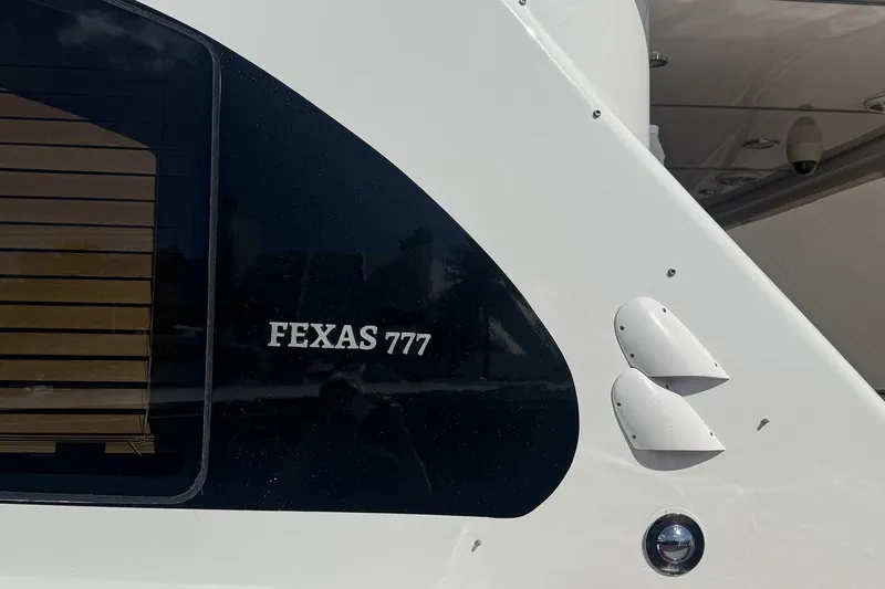 Compass Rose Yacht Photos Pics 1995 Heisley Flybridge boat with "FEXAS 777" marking, featuring sleek design elements.