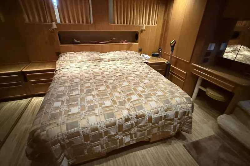 Compass Rose Yacht Photos Pics Luxurious 1995 Heisley Flybridge cabin with cozy bed and elegant wood furnishings.