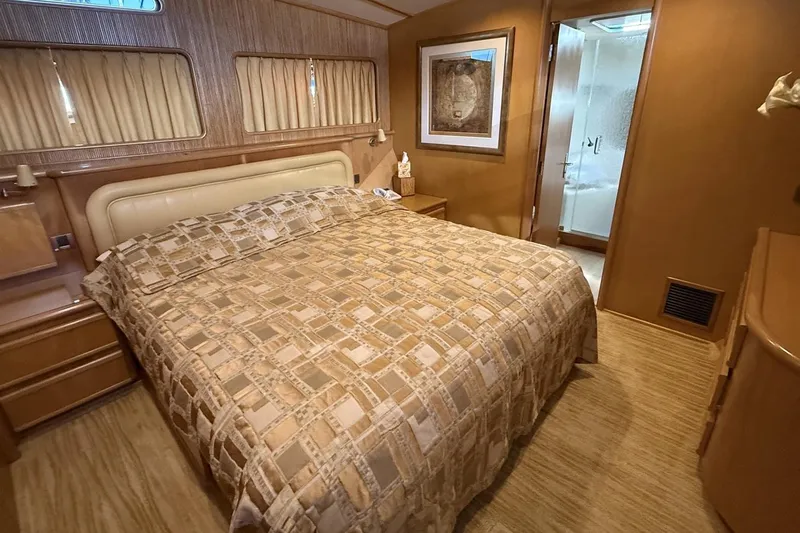 Compass Rose Yacht Photos Pics Luxurious bedroom interior of a 1995 Heisley Flybridge yacht with elegant decor.
