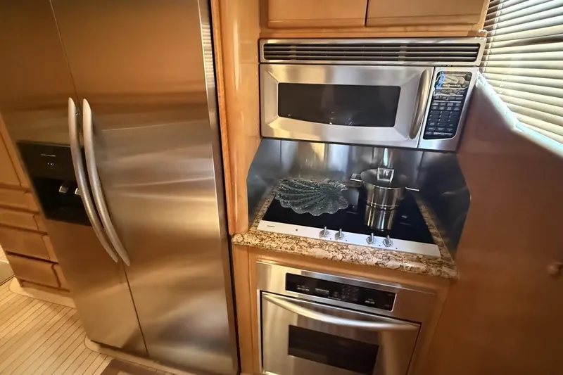 Compass Rose Yacht Photos Pics Modern kitchen in 1995 Heisley Flybridge yacht with stainless steel appliances.