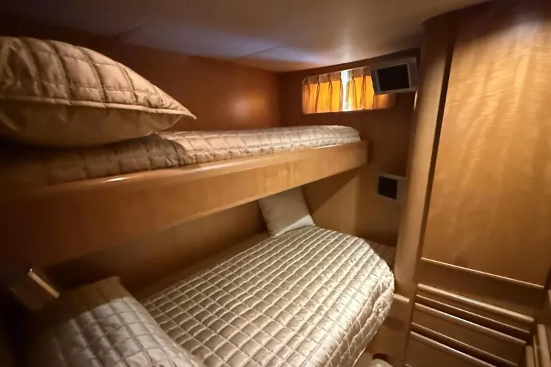Compass Rose Yacht Photos Pics Interior of 1995 Heisley Flybridge yacht with cozy bunk beds and wooden furnishings.