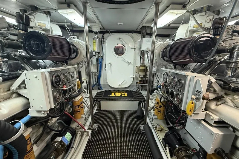 Compass Rose Yacht Photos Pics Engine room of a 1995 Heisley Flybridge yacht, featuring control panels and machinery.
