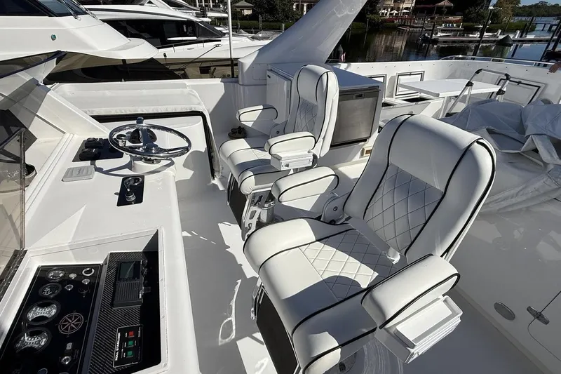 Compass Rose Yacht Photos Pics Luxurious 1995 Heisley Flybridge yacht interior with plush seating and modern controls.