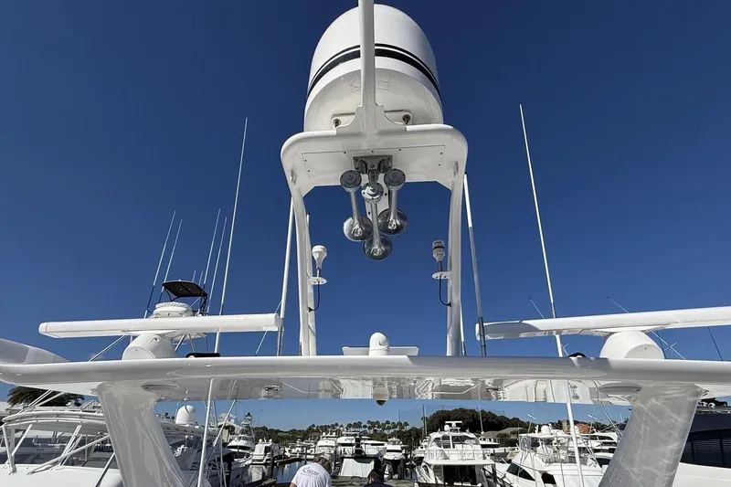 Compass Rose Yacht Photos Pics 1995 Heisley Flybridge yacht with radar and antennas, docked under clear blue sky.