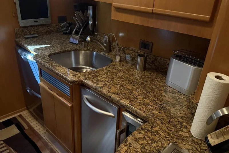 Compass Rose Yacht Photos Pics Luxurious kitchen area in a 1995 Heisley Flybridge yacht with granite countertops.