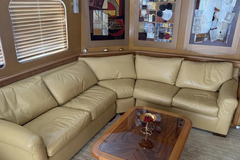 Compass Rose Yacht Photos Pics Luxurious interior of 1995 Heisley Flybridge yacht with leather sofa and modern art.