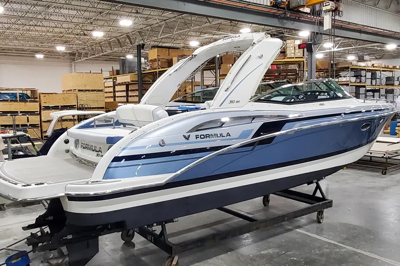  Yacht Photos Pics 2020 Formula 310 Bowrider boat in a warehouse, showcasing sleek design and modern features.