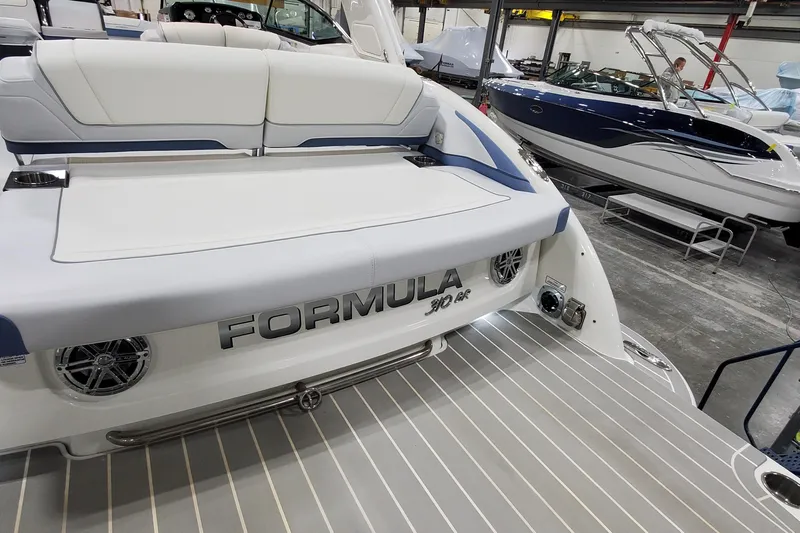  Yacht Photos Pics 2020 Formula 310 Bowrider boat in showroom, featuring sleek design and spacious seating.
