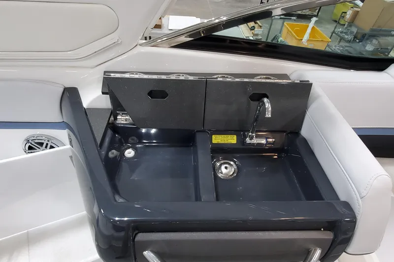  Yacht Photos Pics 2020 Formula 310 Bowrider boat sink with faucet and storage compartments.