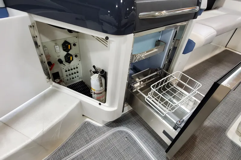  Yacht Photos Pics 2020 Formula 310 Bowrider interior showing control panel and open storage compartment.
