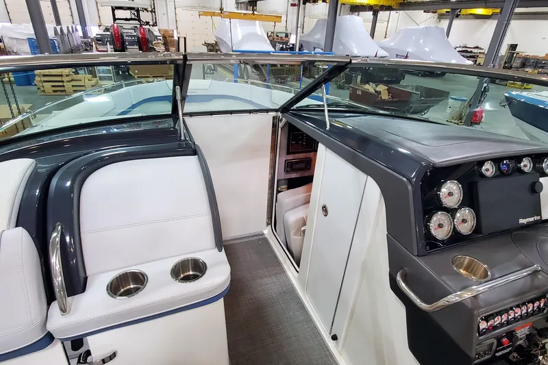 Yacht Photos Pics 2020 Formula 310 Bowrider interior with dashboard, gauges, and seating in a showroom.