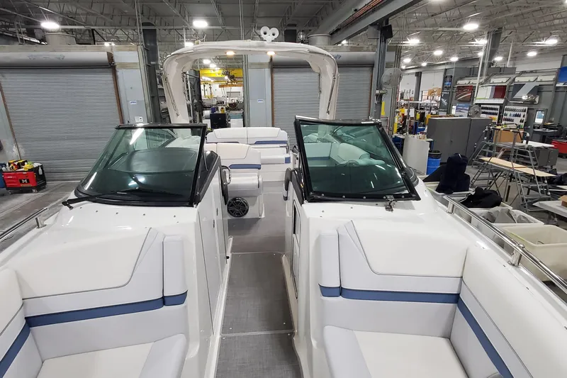 Yacht Photos Pics 2020 Formula 310 Bowrider interior in a factory setting, showcasing seating and design.