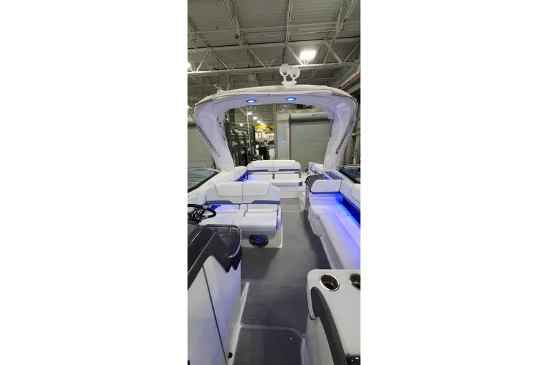  Yacht Photos Pics 2020 Formula 310 Bowrider interior with blue LED lighting in a warehouse setting.