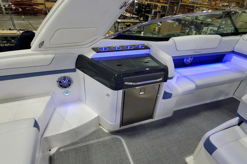  Yacht Photos Pics 2020 Formula 310 Bowrider interior with seating, cup holders, and ambient blue lighting.