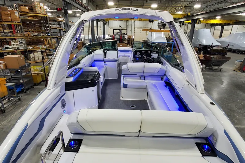  Yacht Photos Pics 2020 Formula 310 Bowrider boat interior with blue LED lighting in a warehouse setting.