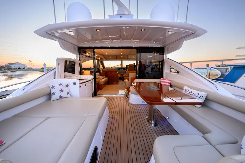 Endless Summer Yacht Photos Pics Luxurious 2006 Princess V65 yacht interior with elegant seating and dining area at sunset.