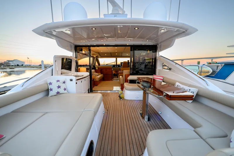 Endless Summer Yacht Photos Pics Luxurious 2006 Princess V65 yacht interior with spacious seating and elegant design at sunset.