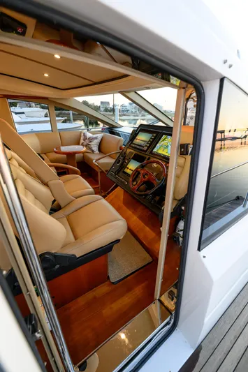 Endless Summer Yacht Photos Pics Interior view of 2006 Princess V65 yacht, featuring luxurious seating and advanced navigation controls.