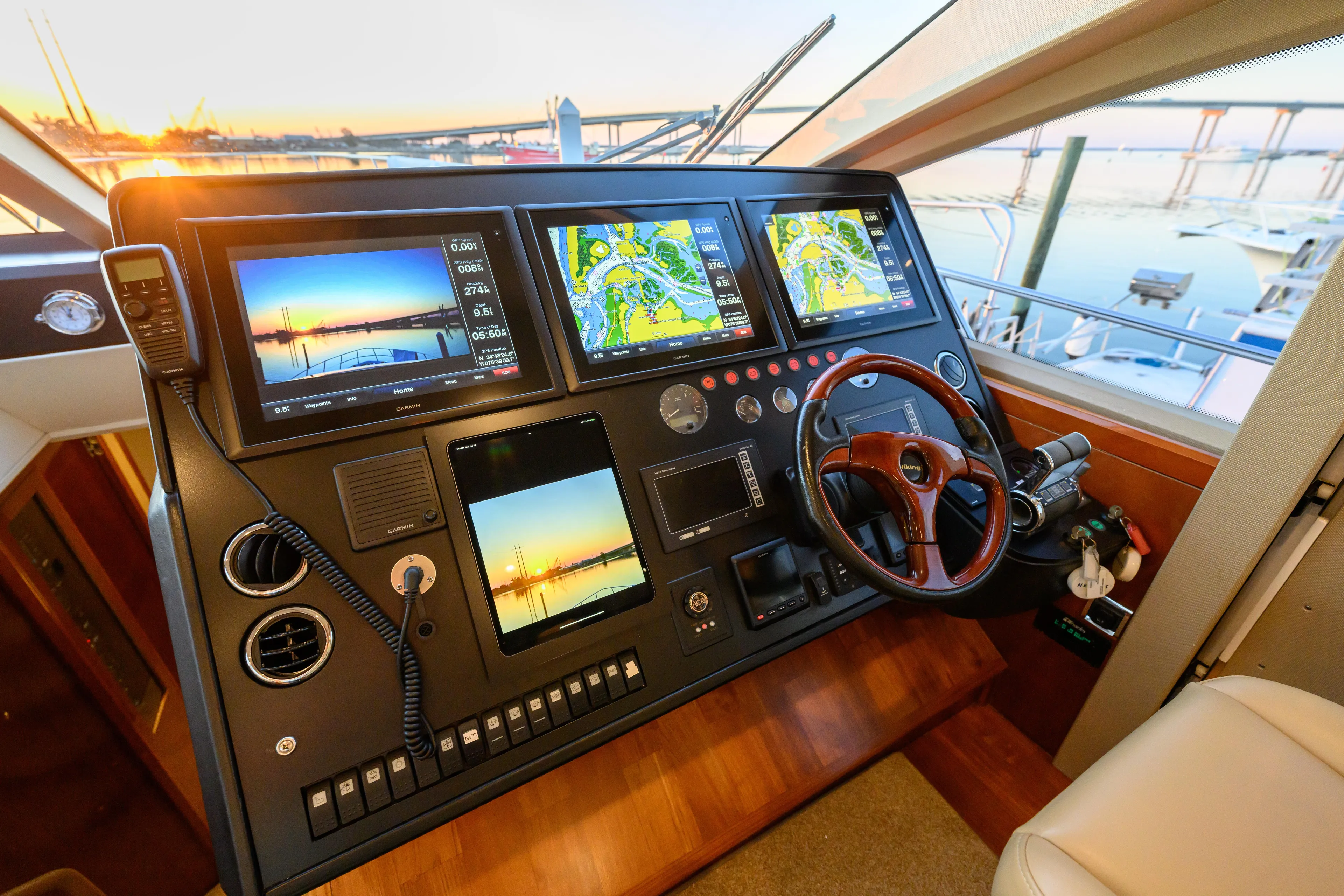 Endless Summer Yacht Photos Pics Control panel of a 2006 Princess V65 yacht with navigation screens and steering wheel.